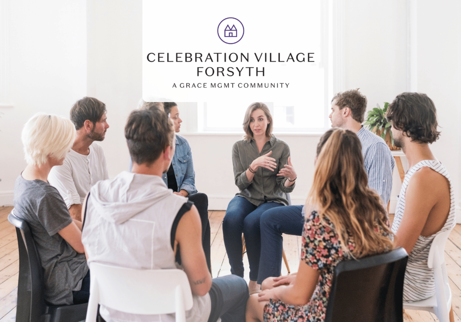 Group of people seated in a circle in a bright room, a woman in the center speaks with hand gestures, banner reads 'Celebration Village Forsyth' above.